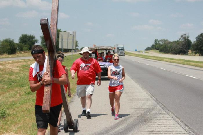 Nineteen-year-old college student Junior Garcia is seen with members of the Oasis Church as he walks along a highway in Texas on his cross-country trip to Washington, D.C.