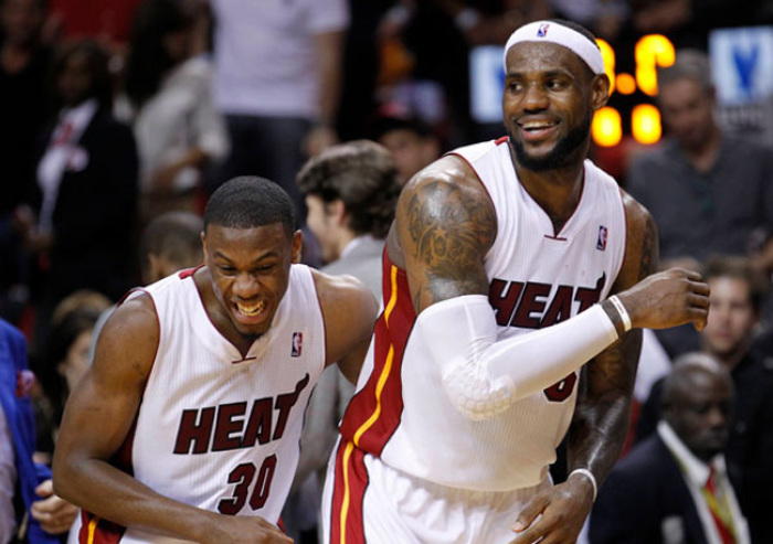 Miami Heat rookie Norris Cole (left) celebrates with LeBron James (right).