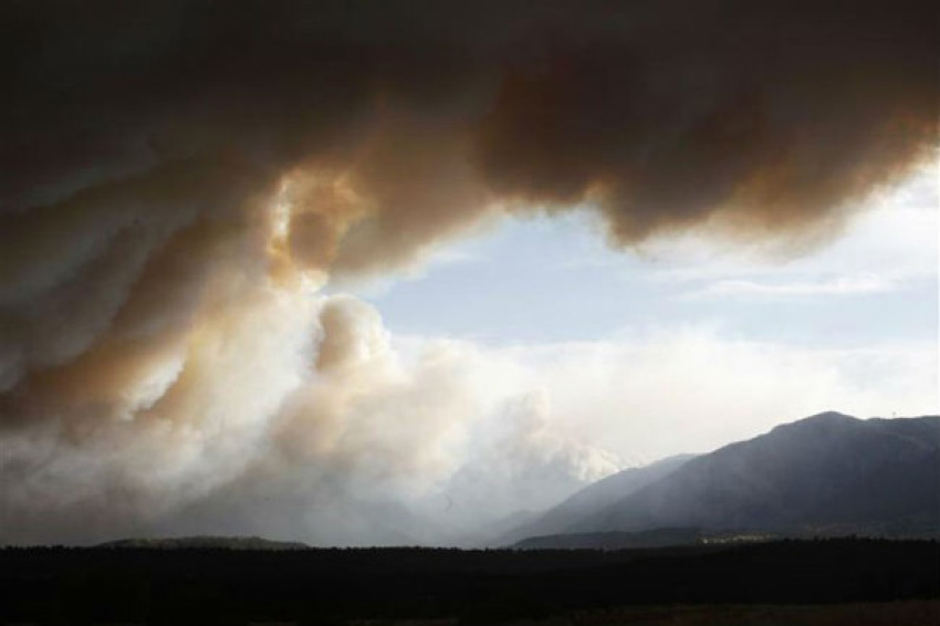 Smoke from the Waldo Canyon fire hovers over the U.S. Air Force Academy west of Colorado Springs in Colorado June 26, 2012. A monster Colorado wildfire raging near some of the most visited tourist areas in the state took a turn for the worse on Tuesday as hot winds pushed flames north, prompting the evacuation of 7,000 more people, officials said.