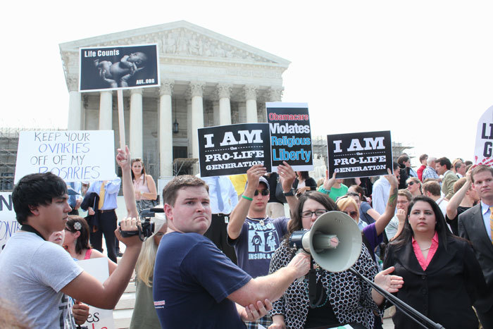Pro-life group Students for Life demonstrates outside of the U.S. Supreme Court on Thursday, June 28, 2012, after the high court decided in a 5-4 ruling that the controversial health care law, including the individual mandate requiring Americans to have health insurance, is valid as a tax.