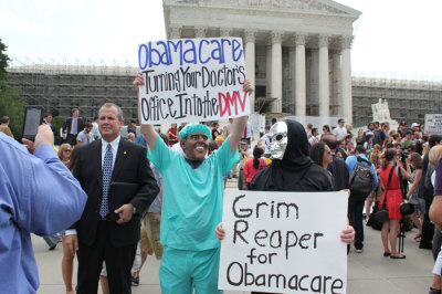 Demonstrators outside of the U.S. Supreme Court on Thursday, June 28, 2012, after the high court decided in a 5-4 ruling that the controversial health care law, including the individual mandate requiring Americans to have health insurance, is valid as a tax.