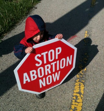 18-month old Joseph holding a Stop Abortion Now sign outside a Planned Parenthood clinic on April 21, 2012.