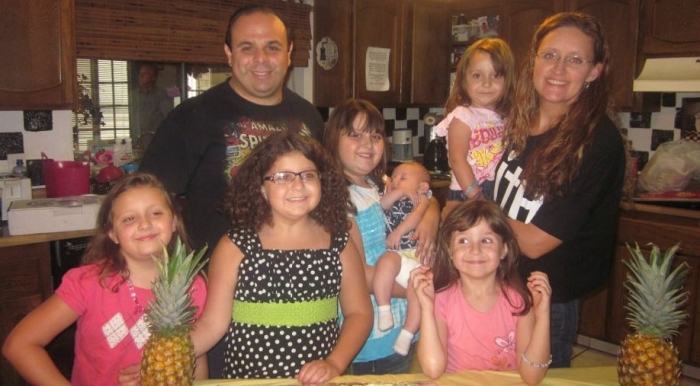 Michael Salman (left), pictured here with his wife Suzanne and six kids, will spend 60 days in jail for hosting Bible studies in his home.