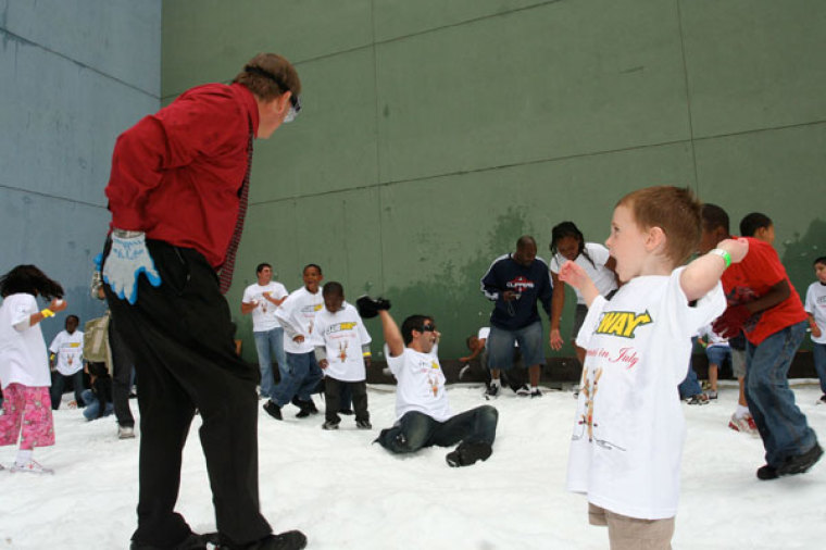 Homeless children, and URM CEO Andy Bales (red), play in 20 tons of snow at the annual Christmas in July event, sponsored by Subway, at Union Rescue Mission in Los Angeles, California, in July 2011.