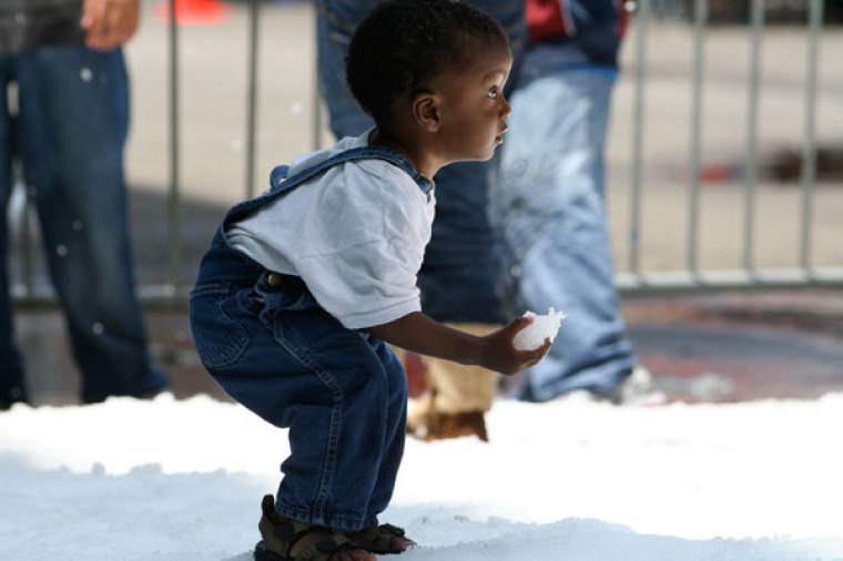 A homeless child plays in 20 tons of snow at the annual Christmas in July event, sponsored by Subway, at Union Rescue Mission in Los Angeles, California, in July 2011.