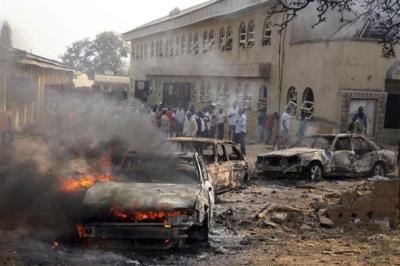 A car burns at the scene of a bomb explosion at St. Theresa Catholic Church at Madalla, Suleja, just outside Nigeria's capital Abuja, December 25, 2011. The Islamist militant group Boko Haram claimed responsibility.