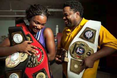 Claressa celebrates her champion belts with her trainer Jason Crutchfield.