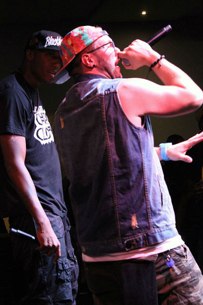 Lecrae watches as Andy Mineo rocks the mic at the Apple store in SOHO, NYC July 17, 2012.