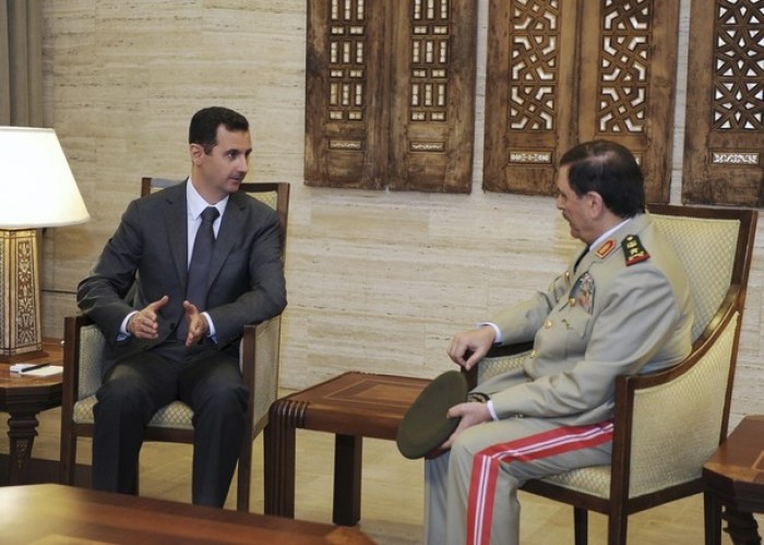 Syrian President Bashar al-Assad meets General Fahad Jassim al-Freij (R), after his swearing-in as Defense Minister in Damascus, in this handout photo distributed by Syrian News Agency (SANA) July 19, 2012.