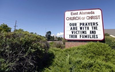 A sign in memory of the victims killed by a gunman that opened fire in a movie theater is seen at the East Alameda Church of Christ in Aurora, Colorado, July 22, 2012. President Barack Obama will travel to Colorado on Sunday to meet with the families of victims of a shooting rampage at a packed midnight showing of the new 'Batman' film in the Denver suburb of Aurora that killed at least 12 people and wounded 58.
