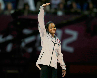 Gold medallist Gabrielle Douglas of the U.S. waves before receiving her gold medal after the women's individual all-around gymnastics final in the North Greenwich Arena at the London 2012 Olympic Games August 2, 2012.