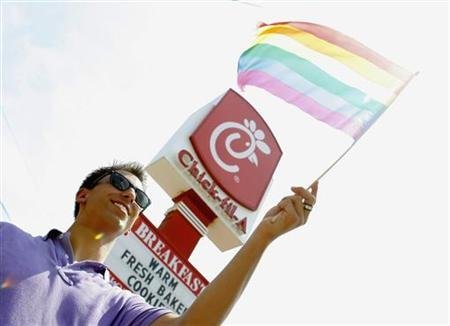 Paul Beauchamp waves a gay pride flag during a nationwide "kiss-in" and protest at a Chick-Fil-A restaurant in Decatur, Georgia, August 3, 2012.