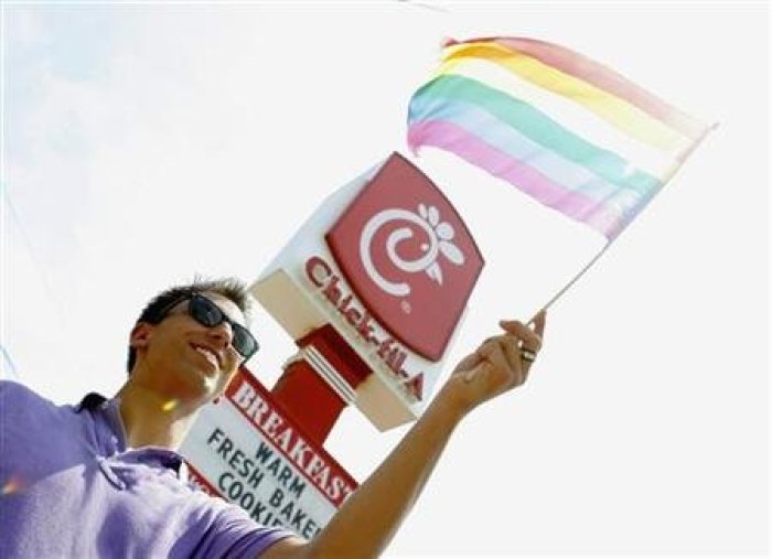 Paul Beauchamp waves a gay pride flag during a nationwide 'kiss-in' and protest at a Chick-Fil-A restaurant in Decatur, Georgia, August 3, 2012.