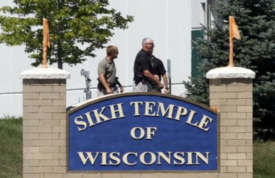 Officials gather near the Sikh Temple in Oak Creek in Wisconsin August 5, 2012 following a mass shooting inside and outside the Sikh Temple. A shooting during Sunday services at a Sikh temple left at least seven people dead, including a gunman, and at least three critically wounded, police and hospital officials said.