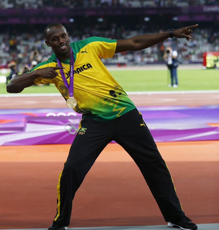 Jamaica's Usain Bolt strikes his famous pose with his gold medal at the men's 200m victory ceremony during the London 2012 Olympic Games at the Olympic Stadium August 9, 2012.