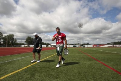 New York Jets quarterback Tim Tebow walks off the field after Jets training camp practice in Cortland, New York, July 27, 2012.