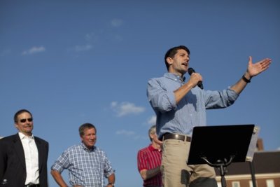 Republican vice presidential candidate Representative Paul Ryan (R-WI) (C) speaks during a campaign rally at Miami University in Oxford, Ohio August 15, 2012. Seen behind Ryan are Professor Rich Hart (L), Ohio Governor John Kasich and Senator Rob Portman (R-OH) (partially hidden, R).