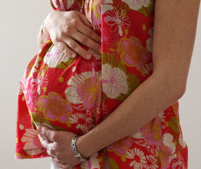 A woman holds her stomach at the last stages of her pregnancy in Bordeaux April 28, 2010.