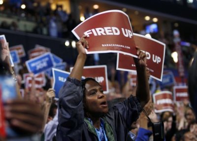 Delegates hold a signs during the final session of the Democratic National Convention in Charlotte, North Carolina September 6, 2012.