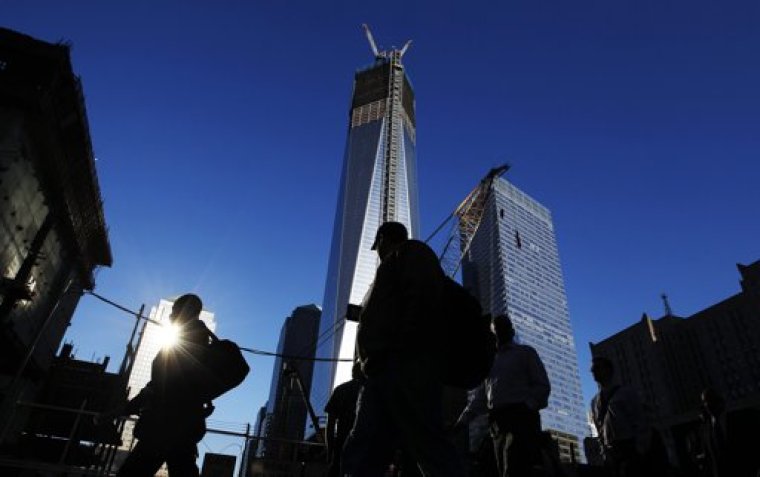 People walk by the World Trade Center site before ceremonies marking the 11th anniversary of the September 11, 2001 attacks on the World Trade Center at Ground Zero in New York September 11, 2012.