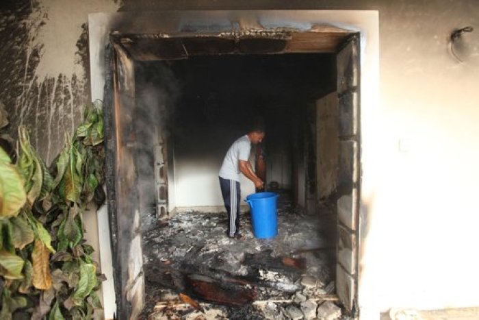 A man stands inside the U.S. consulate, which was attacked and set on fire by gunmen yesterday, in Benghazi September 12, 2012.