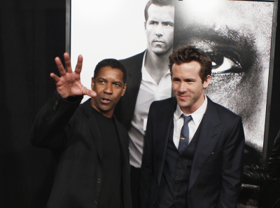 Cast members Ryan Reynolds (R) and Denzel Washington arrive to attend the world premiere of the film 'Safe House' in New York February 7, 2012.