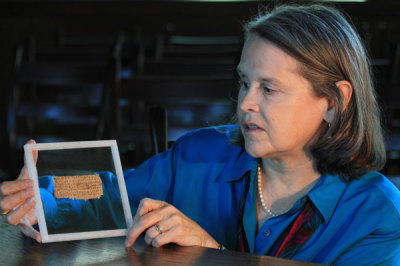 Dr. Karen King, the Hollis Professor of Divinity at Harvard Divinity School, holds up an ancient papyrus, labeled 'The Gospel of Jesus' Wife.'