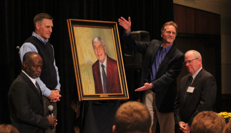 Evangelical mission leaders present an oil-painting of David J. Hesselgrave to Trinity Evangelical Divinity School's Dean Tite Tienou (bottom left) and Trinity International University President G. Craig Williford (bottom right) at the North American Mission Leaders Conference on Friday, Sept. 22, 2012, in Chicago. The portrait of Hesselgrave, who was given the Lifetime of Service Award, will hang in the school's hallway.