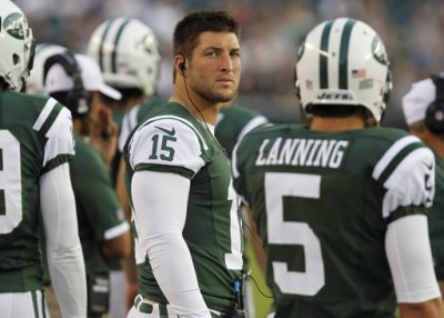New York Jets quarterback Tim Tebow (15) watches from the sideline while playing against the Philadelphia Eagles during the first quarter of their NFL preseason football game in Philadelphia, Pennsylvania, August 30, 2012.