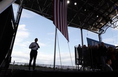 U.S. President Barack Obama jogs onto the stage for a campaign rally at the Henry Maier Festival in Milwaukee, Wisconsin September 22, 2012.