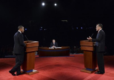 Republican presidential nominee Mitt Romney answers a question as President Barack Obama and moderator Jim Lehrer listen during the first 2012 U.S. presidential debate in Denver October 3, 2012.