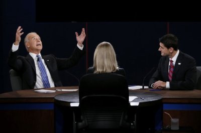 U.S. Vice President Joe Biden (L) makes a point in front of Republican vice presidential nominee Paul Ryan and moderator Martha Raddatz (C) during the vice presidential debate in Danville, Kentucky, October 11, 2012.