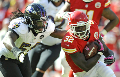 Kansas City Chiefs running back Cyrus Gray (R) is grabbed by Baltimore Ravens linebacker Dannell Ellerbe during the second half of the Ravens' win in their AFC NFL football game in Kansas City, Missouri October 7, 2012.