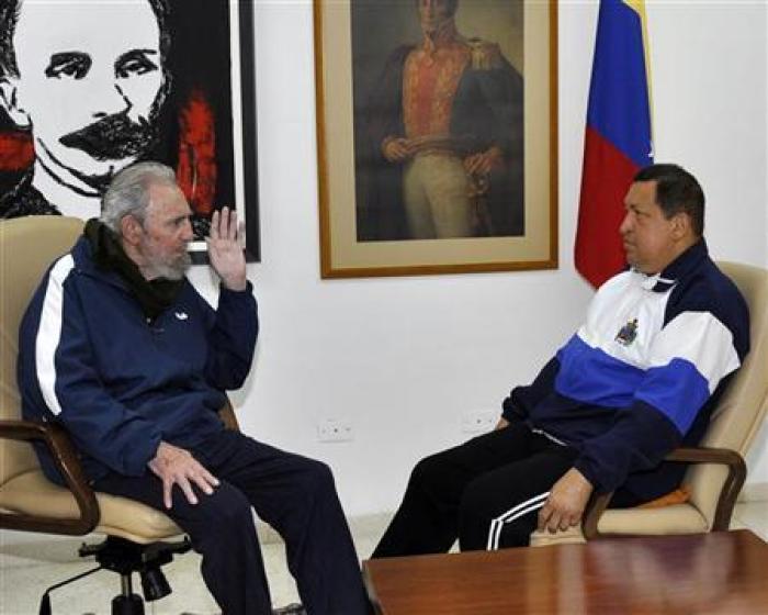Former Cuban President Fidel Castro (L) visits Venezuela's President Hugo Chavez, who is recovering from surgery, in Havana March 2, 2012.