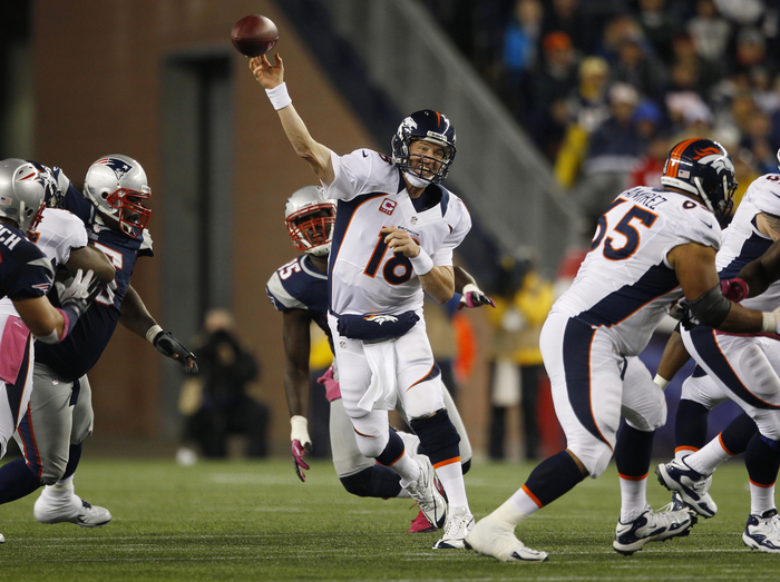 Denver Broncos quarterback Peyton Manning (C) passes against the New England Patriots during the second half of their NFL football game in Foxborough, Massachusetts October 7, 2012.