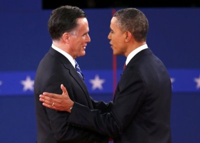 U.S. Republican presidential nominee Mitt Romney (L) shakes hands with President Barack Obama at the start of the second U.S. presidential debate in Hempstead, New York, October 16, 2012.