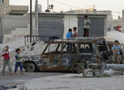 Children play on burnt cars in Aleppo October 18, 2012.