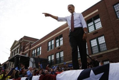 U.S. President Barack Obama takes the stage to address supporters at a campaign rally at Elm Street Middle School in Nashua, New Hampshire, October 27, 2012.