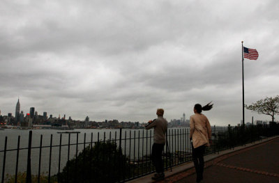 People look at the New York skyline along the Hudson River in Weehawken, New Jersey, October 28, 2012. 