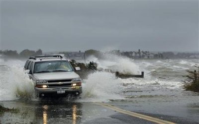 A car drives through water driven onto a roadway by Hurricane Sandy in Southampton, New York, October 29, 2012.