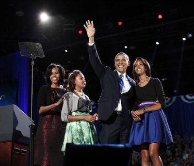 U.S. President Barack Obama gathers with his wife Michelle Obama (L) and daughters Sasha and Malia (R) during his election night victory rally in Chicago November 7, 2012.