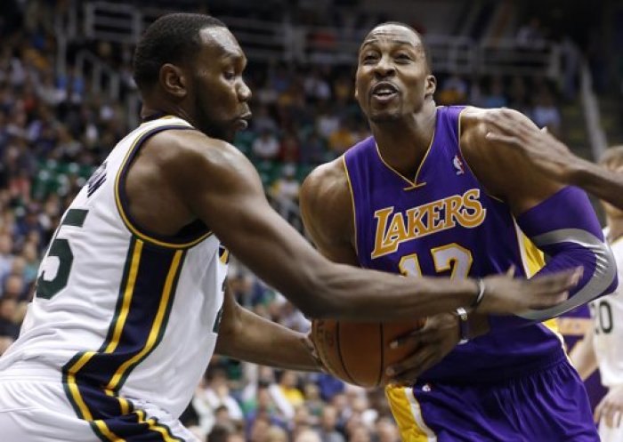 Los Angeles Lakers center Dwight Howard (12) is defended by Utah Jazz center Al Jefferson during the first half of their NBA basketball game in Salt Lake City, Utah, November 7, 2012.