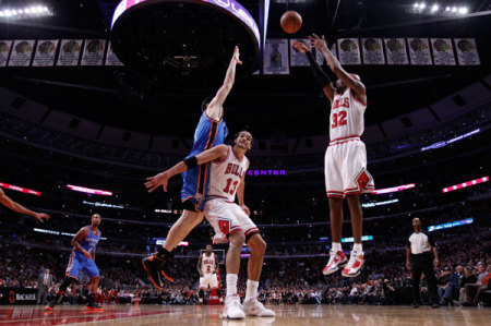 Chicago Bulls shooting guard Richard Hamilton (32) shoots as teammate center Joakim Noah (13) holds back Oklahoma City Thunder power forward Nick Collison (4) during the second half of their NBA basketball game in Chicago, Illinois, November 8, 2012.