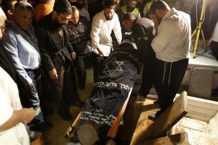 Men lower the body of Aaron Smadja, one of the three Israelis killed by a rocket fired from Gaza, during his funeral at a cemetery in the southern city of Kiryat Malachi on Nov. 15, 2012.
