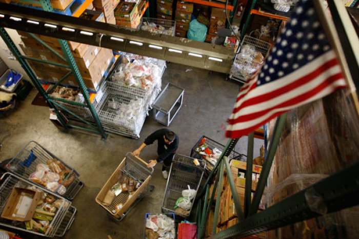 Workers fill carts with food for the poor at the Foothill Unity Center food bank in Monrovia, California, November 14, 2012. 