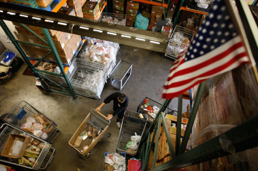 Workers fill carts with food for the poor at the Foothill Unity Center food bank in Monrovia, California, November 14, 2012. The number of people served by Foothill Unity Center has tripled in the last four years. Groups that provide food for pantries say this is one of the toughest years yet in terms of low levels of federal government "surplus" commodity donations, which have accounted for a major portion of meat and other proteins in the past. Those shortfalls are putting real pressure on low income families and individuals, who are more squeezed than ever because of still high unemployment, federal and state budget cuts, higher grocery costs from recent drought, rising rents and transport costs.