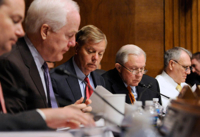 (L-R) Republican U.S. Senators Michael Lee (R-UT), John Cornyn (R-TX), Lindsey Graham (R-SC), Jeff Sessions (R-AL) and Jon Kyl (R-AZ) go over their notes as they wait to question U.S. Attorney General Eric Holder (not pictured) as he testifies before the Senate Judiciary Committee on Capitol Hill in Washington, June 12, 2012.