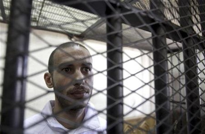 Computer science graduate Alber Saber, 27, is seen inside the cage during his trial in Cairo September 26, 2012.
