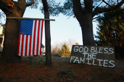 A sign and a U.S. national flag are seen near Sandy Hook Elementary School in Sandy Hook in Newtown, Connecticut December 15, 2012. Residents of the small Connecticut community of Newtown were reeling on Saturday from one of the worst mass shootings in U.S. history, as police sought answers about what drove a 20-year-old gunman to slaughter 20 children at an elementary school.