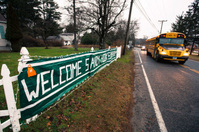 A school bus drives past a welcome sign outside the entrance for Chalk Hill Middle School, where students displaced from Sandy Hook Elementary School will begin their classes on Tuesday, in Monroe, Connecticut, December 17, 2012. Twelve girls, eight boys and six adult women were killed in a shooting on Friday at Sandy Hook Elementary School in Newtown.